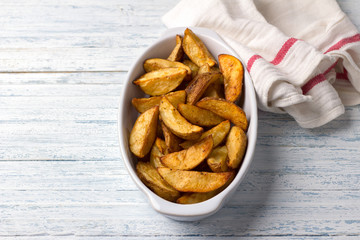 Baked potatoes on a light blue background, selective focus. Delicious vegan homemade food