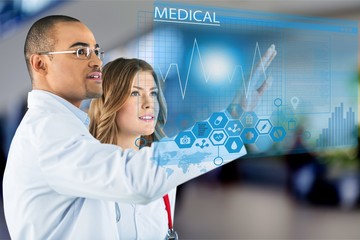 Two doctors with modern computer interface as