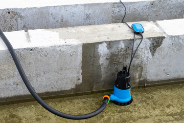 Submersible pump dewater construction site, pumping flood water sing deep well.