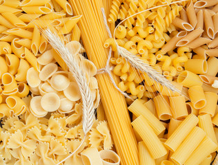 composition of raw pasta different shapes, frame of raw pasta. room for text 