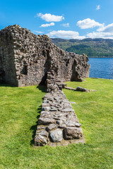 Urquhart Castle along Loch Ness lake in Scotland in a beautiful summer day. vertical. ruins.