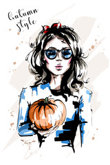 Hand drawn beautiful young woman holding pumpkin. Stylish elegant girl with red bow in her hair. Fashion woman in sunglasses. Sketch.