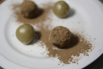 Four gluten free truffles on a white plate