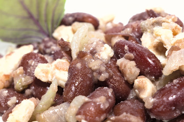 Red beans with chicken and Basil leaves, on a white plate