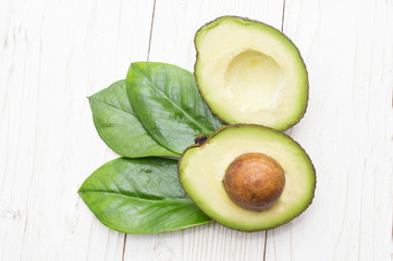 Avocado isolated on a white wooden background