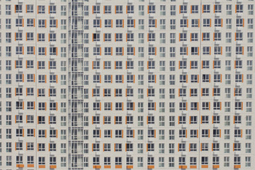 Multi-storey white house with orange inserts