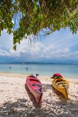 Red and yellow boats on the beach on the Mamutik Island, Sabah, Malaysia.