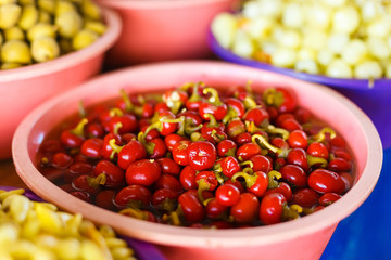 Counter with marinated pepper on the market