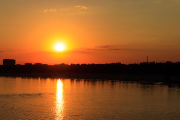 Orange sunset over a river Dnieper in Kremenchug city, Ukraine