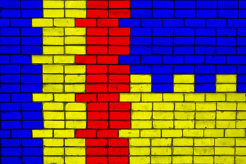 Colors of national flags of Romania and Ukraine on a brick wall texture