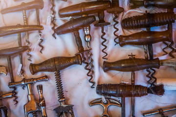 A collection of old wine corkscrews. Retro items on a vintage flea market