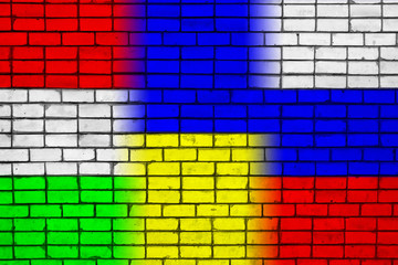 Colors of national flags of Hungary, Ukraine and Russia on a brick wall texture