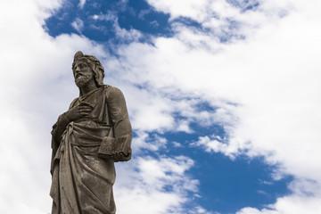 Fototapeta na wymiar Statue of Jesus alone in a cemetery