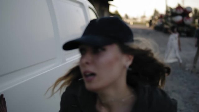 The Scene Of The Scared Girl Runs Away From The Zombie, Hiding Behind The White Van Then Run Away. Two Creepy Zombies Coming For Her. Filming, Halloween, Horror Concept