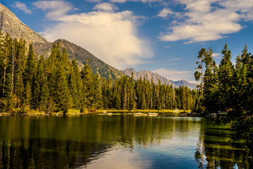 The massive Teton peaks look out over Leigh Lake in the Grand Teton National Park in Wyoming....