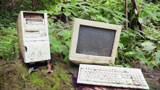Pull Back Reveal of a dirty vintage computer abandoned in the jungle, Costa Rica