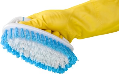 Yellow cleaning glove with a brush isolated on white