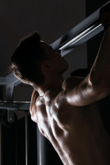 muscular man flexing his muscles working out in a gym