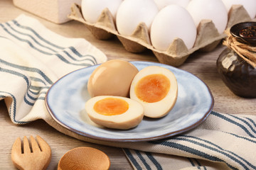 Plate of soft boiled eggs on wooden table