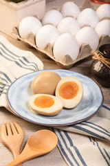 Plate of soft boiled eggs on wooden table