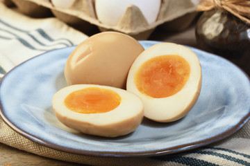 Plate of soft boiled eggs on wooden table