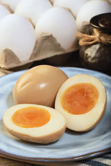 Plate of soft boiled eggs on wooden table