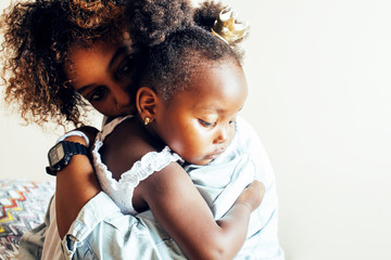 adorable sweet young afro-american mother with cute little daugh
