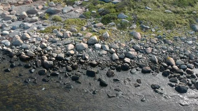 Aerial drone shot of a rocky beach ocean coastline on the west coast of Sweden in Halland, outside of Gothenburg.