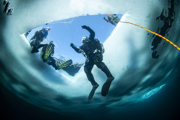 Winter ice diving underwater in a quarry in Canada