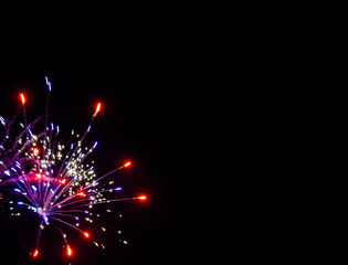 Fototapeta premium Celebratory fireworks on black background portrait orientation room for text