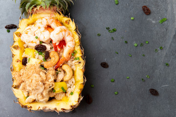 Fried rice with seafood served in a pineapple
