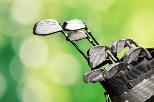 Different golf clubs on  background.