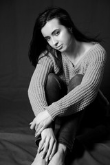Black and white photo of beautiful brunette girl posing in studio.