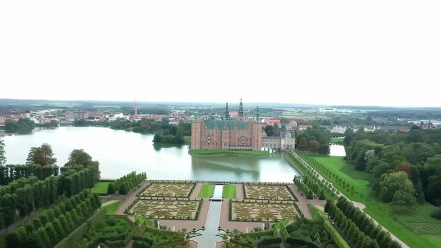 Aerial shot over an opulent garden and castle in Hillerod Denmark