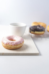 Donuts and a cup of coffee on white background