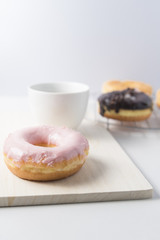Donuts and a cup of coffee on white background