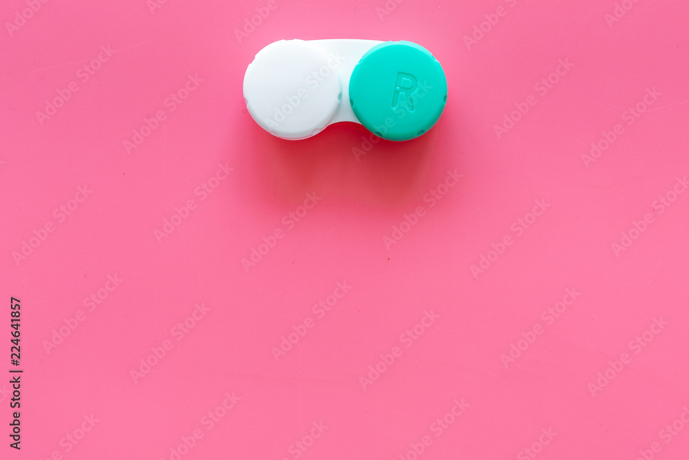 Wall mural Improve vision concept. Contact lenses in container on pink background top view copy space