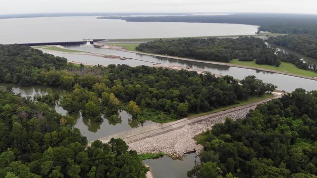Drone aerial pan of Lake Houston, dam, San Jacinto River, and forest