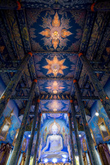 View of amazing interior of vibrant Wat Rong Suea Ten (also known as Blue Temple) with bright ornaments in design, Thailand