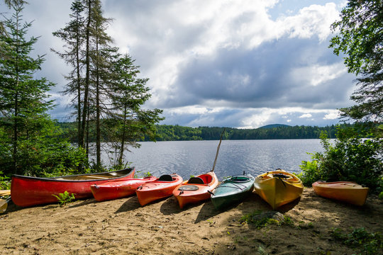 Kayaks and a canoe by the Indian lake in upstate NY (USA)