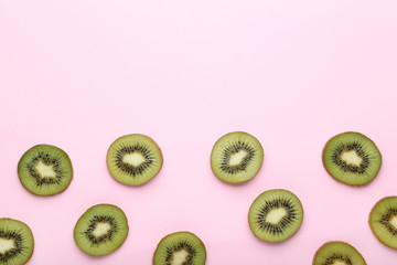 Sliced kiwi fruits on pink background