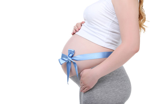 Pregnant woman with blue ribbon on white background