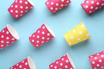 Colorful paper cups on blue background