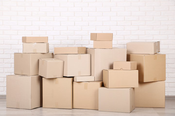 Cardboard boxes on brick wall background
