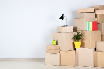 Cardboard boxes with household stuff on grey background