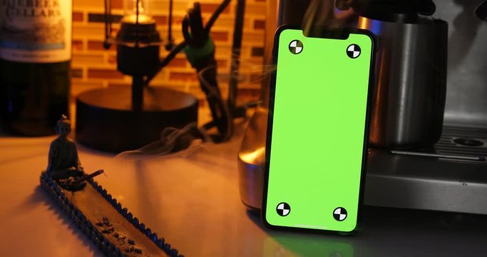 Woman holding green screen smartphone