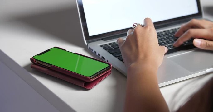 Green Screen Phone next to laptop