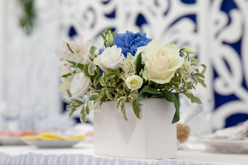white ceramic pot with flowers on the table for holiday decoration