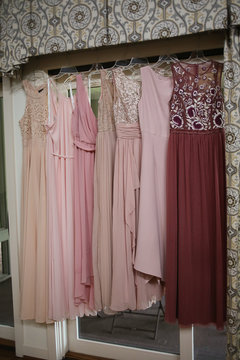 Wedding Photography Mismatched Pink Bridesmaid Dresses Hanging In Front Of French Doors