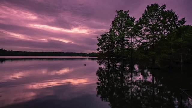 A view of the sunset reflecting in the glassy water at stumpy lake.